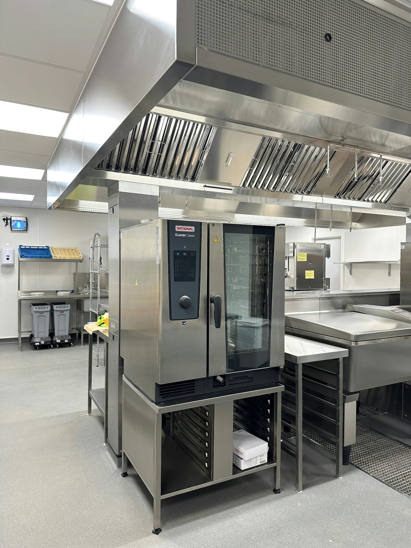 Combi oven beneath a stainless exhaust canopy