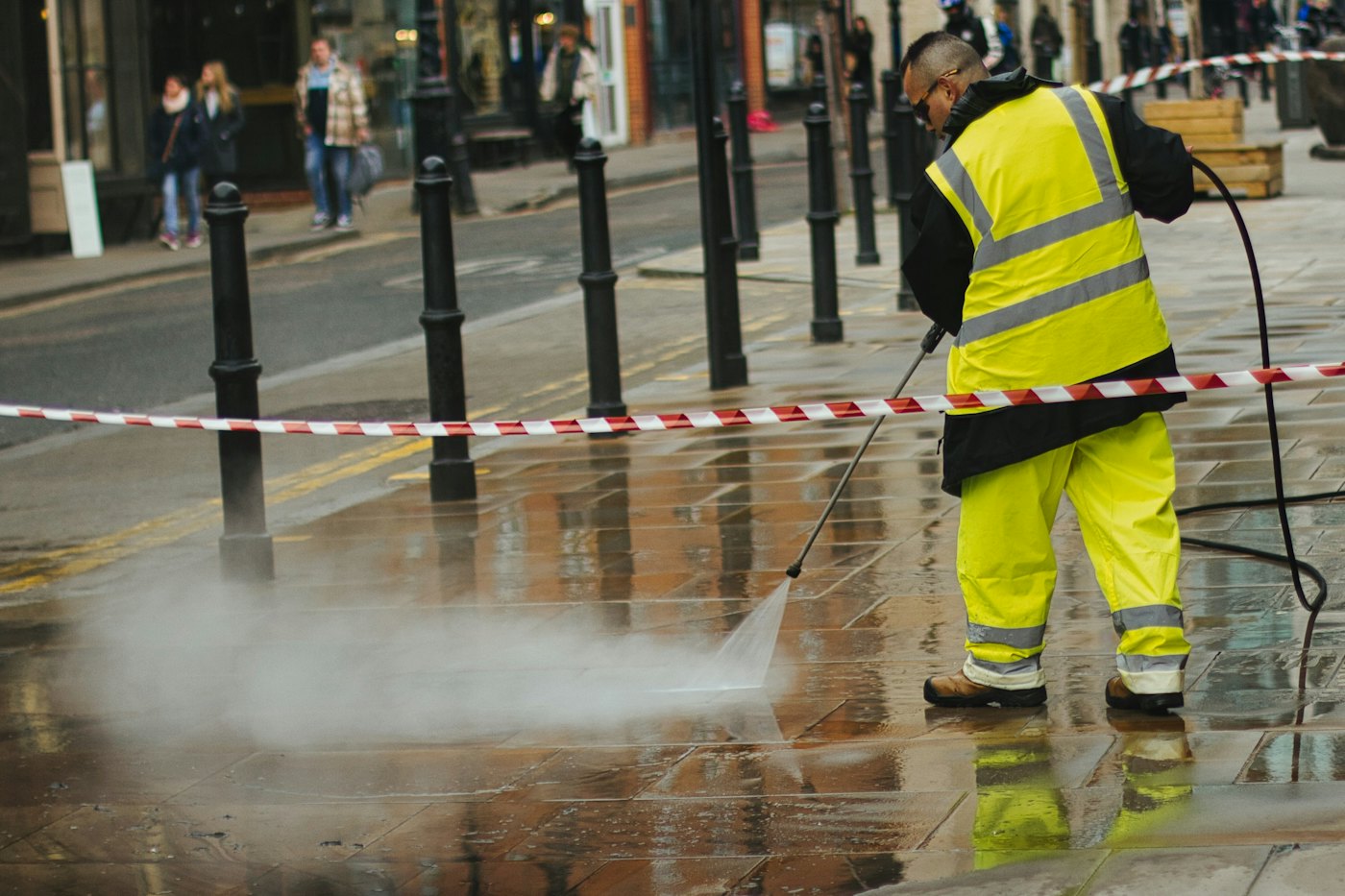 Worker using a hot water pressure washer